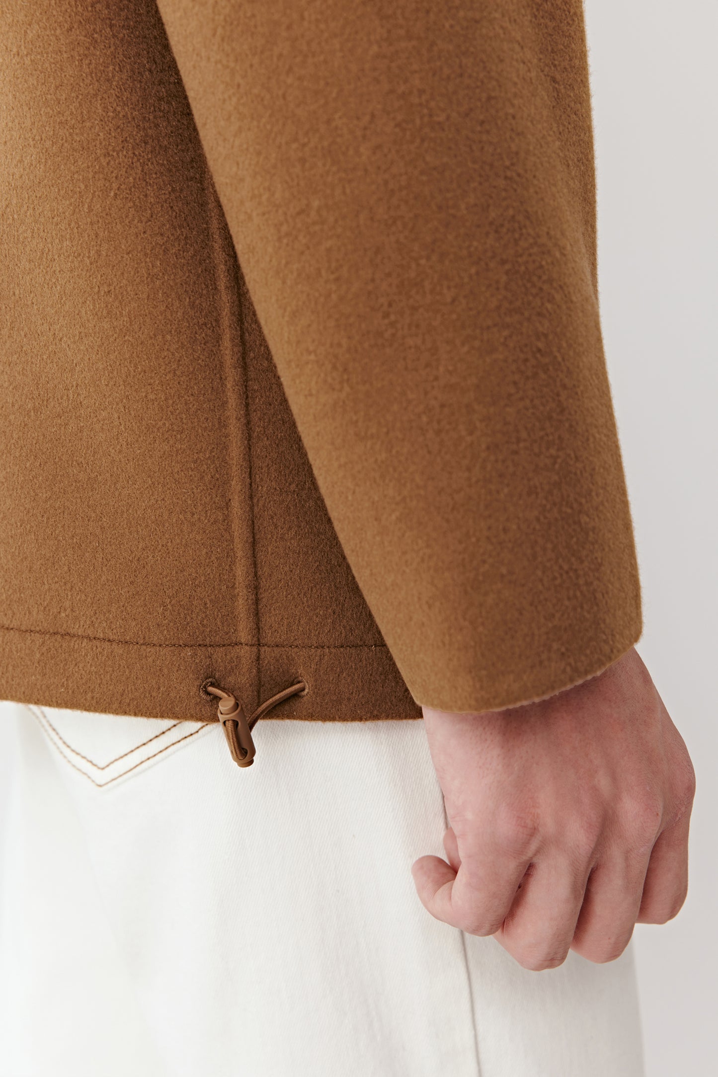Close-up of the hood and shoulder details, emphasizing the refined finishing and double-faced wool texture.
