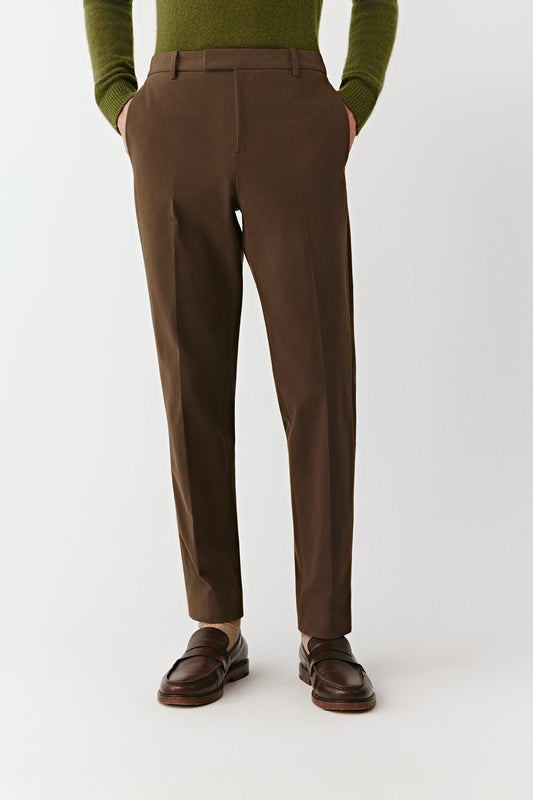 Three-quarter side view of the cotton twill trousers, showing the crisp fit and slightly tapered silhouette.