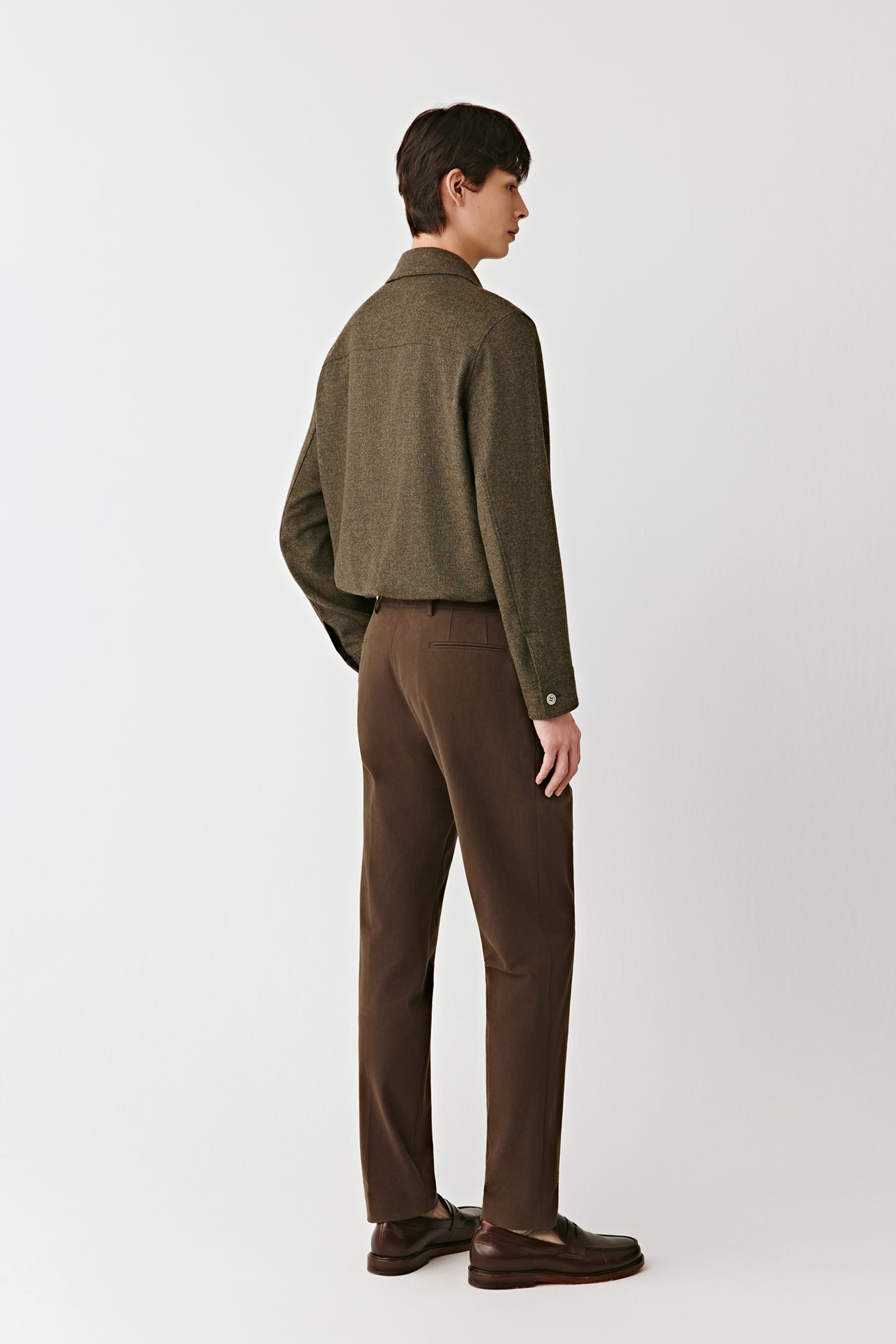 Back view of the khaki green shirt jacket, highlighting the clean tailoring and neat finishing.