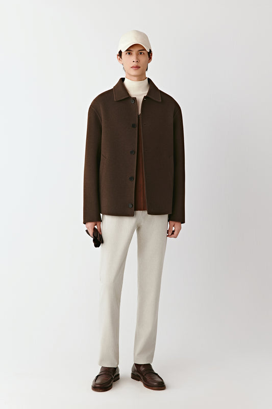 Front view of the chestnut brown double-faced yak wool twill jacket, straight cut with a shirt collar and button closure.