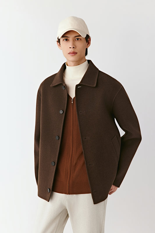 Three-quarter side view of the brown yak wool twill jacket, showing the structured silhouette and fine texture.