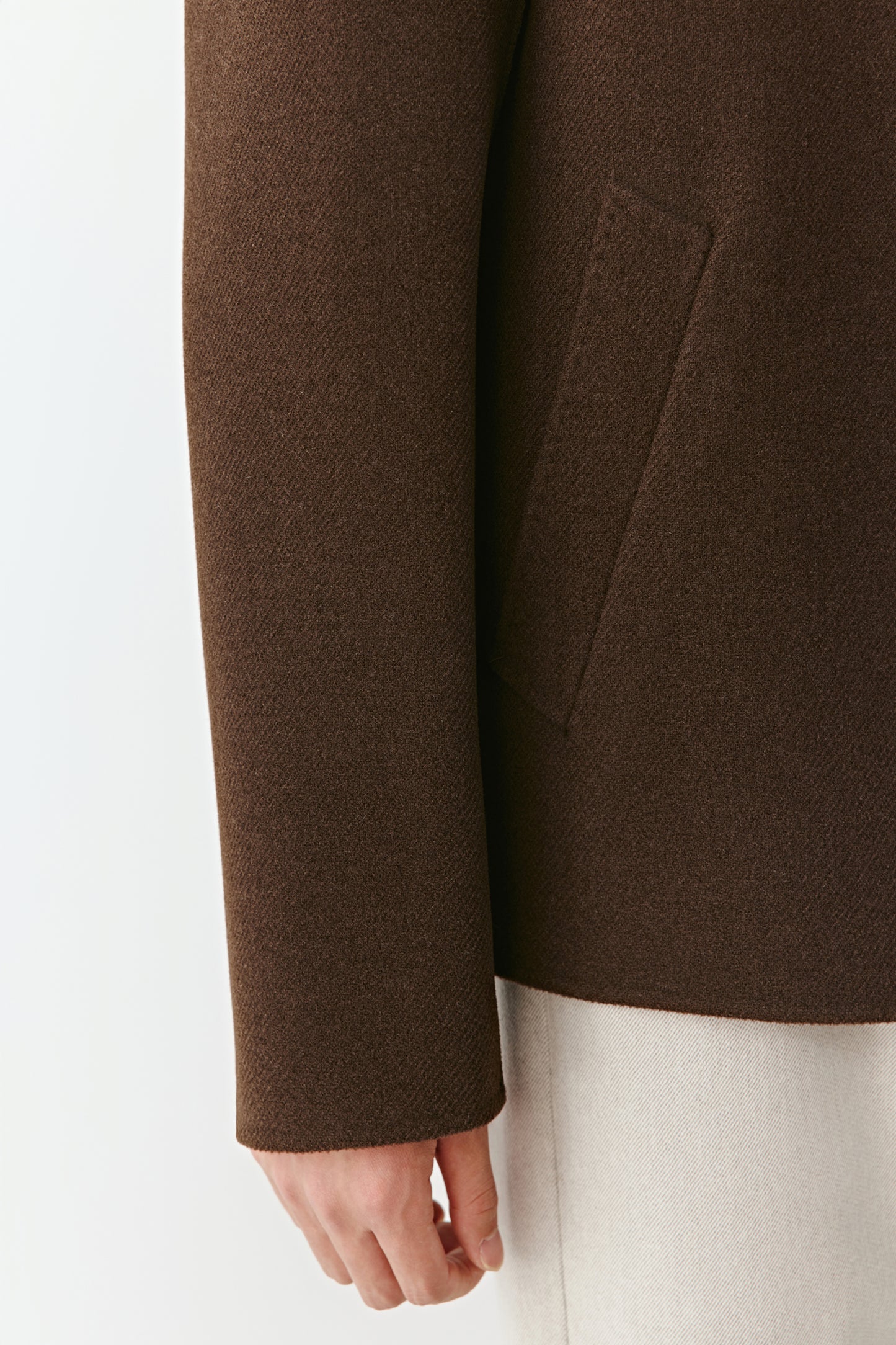 Back view of the jacket, highlighting the clean seams and smooth drape of the thick twill fabric.