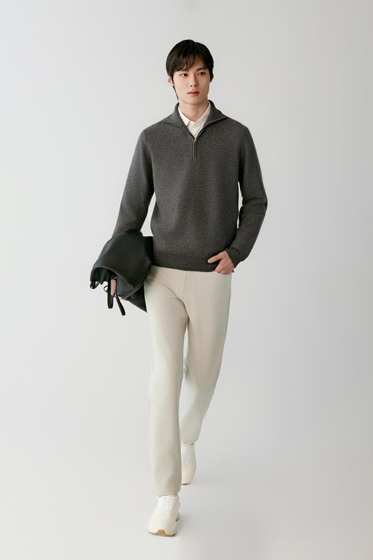 Front view of a man wearing a smoke grey cashmere pullover, showing the half-zip high collar, long sleeves and straight silhouette.