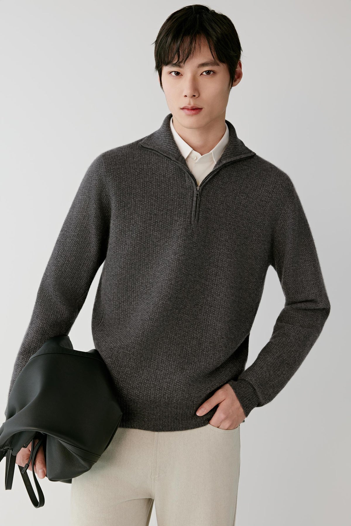 Front view of a man wearing the smoke grey cashmere pullover, highlighting the half-zip collar and textured knit.