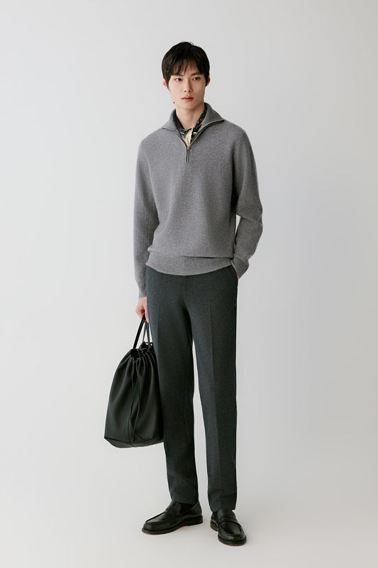 Front view of a man wearing a grey cashmere pullover, showing the half-zip funnel neck, long sleeves and straight silhouette.