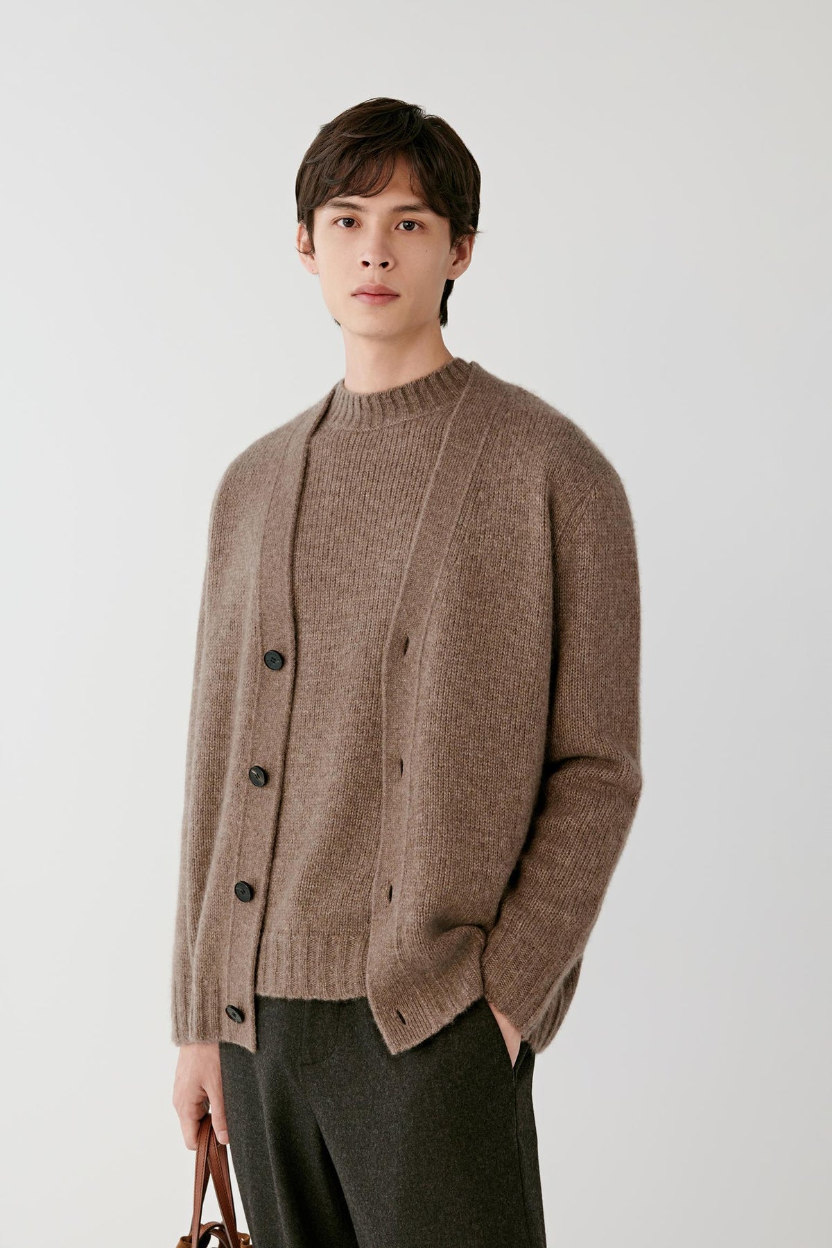 Front view of a man wearing the warm brown cashmere pullover, highlighting the button-front detail and fine ribbed trims.