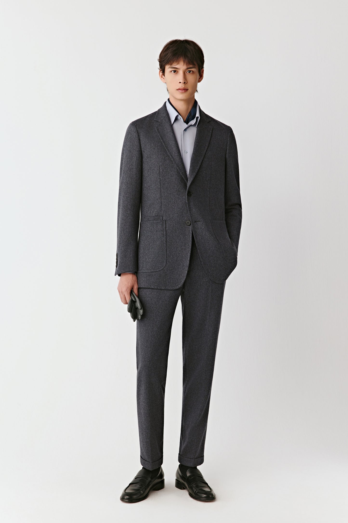 Man wearing a gray suit with a white background