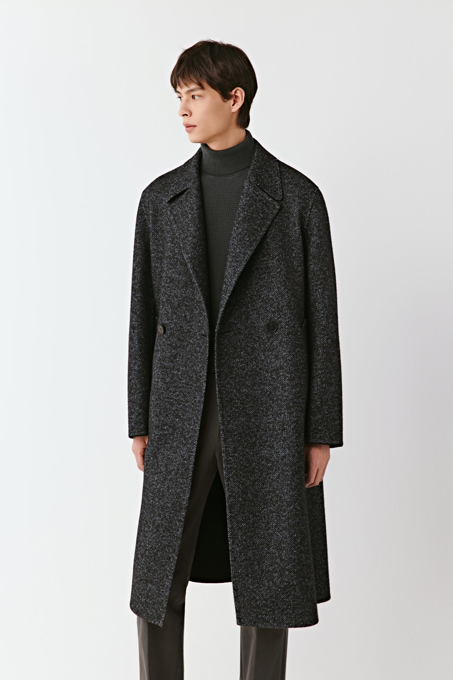 Man wearing a dark gray coat on a white background