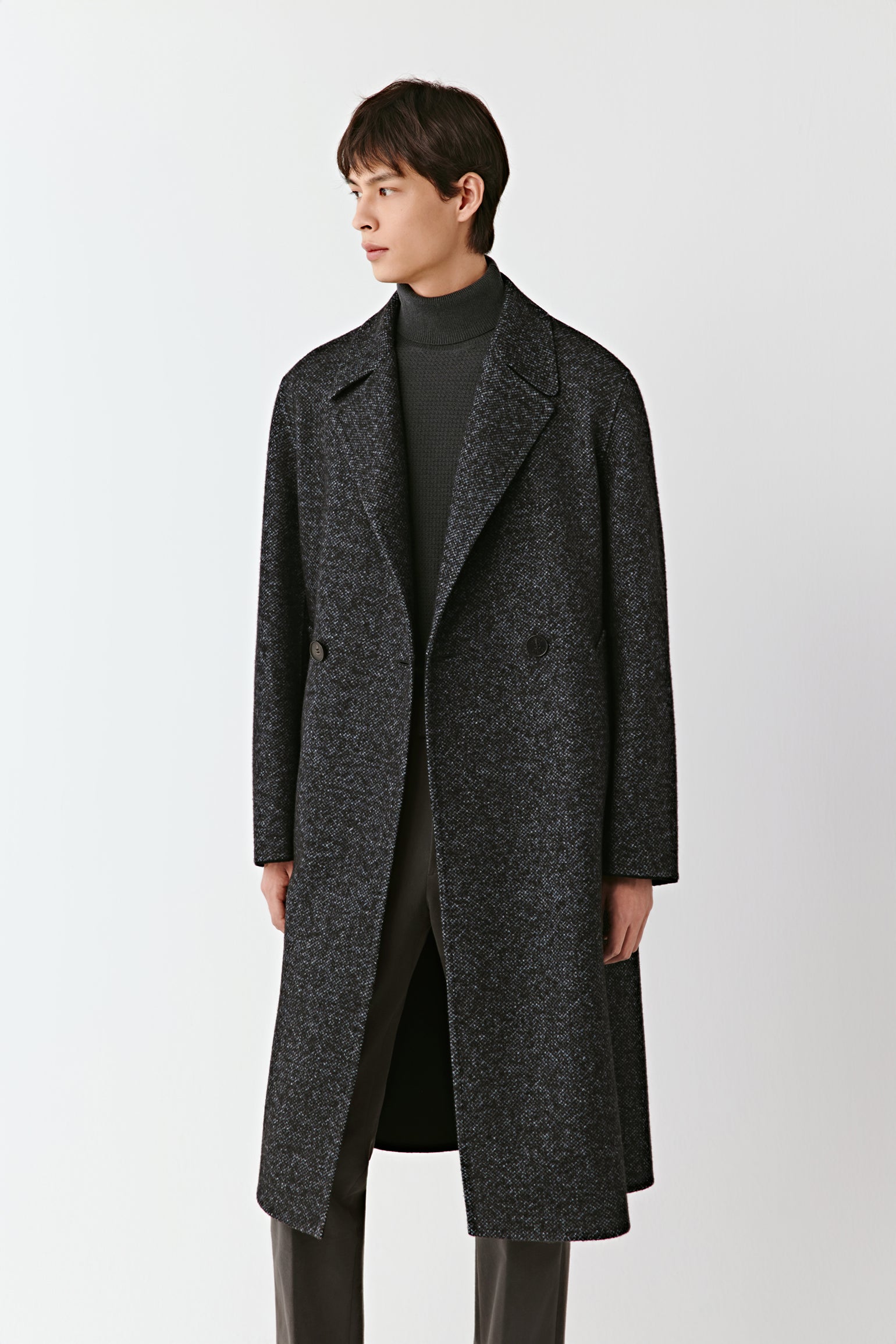 Man wearing a dark gray coat on a white background