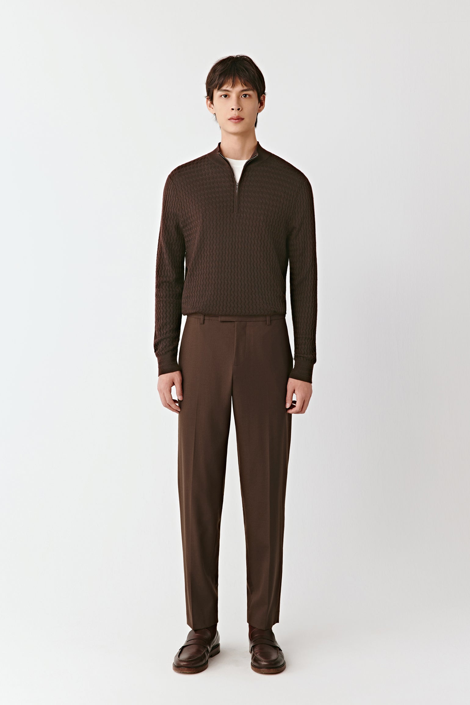 Man wearing a brown outfit on a white background