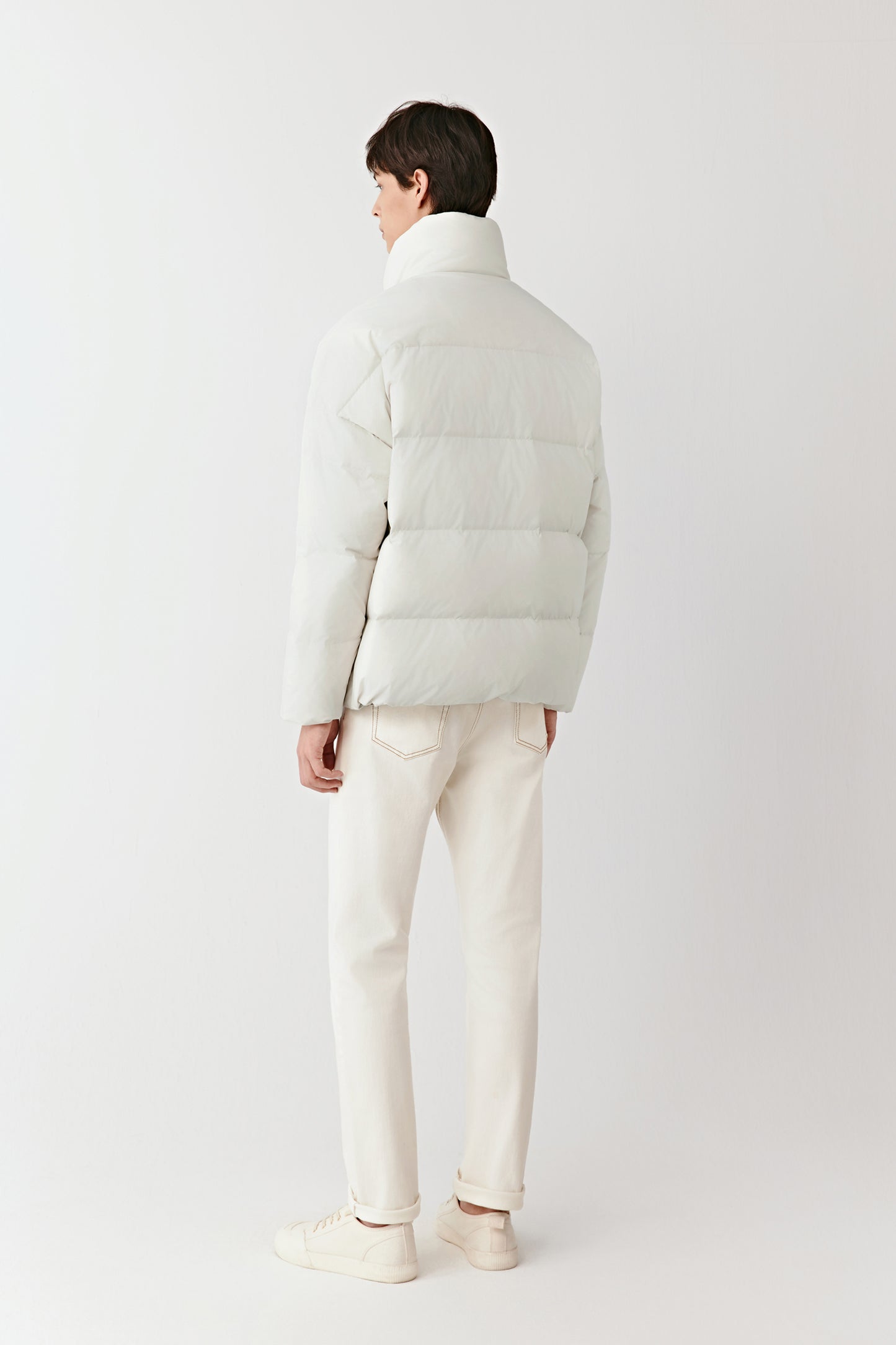 Back view of the cream recycled polyester puffer coat, highlighting the quilted structure and relaxed fit.