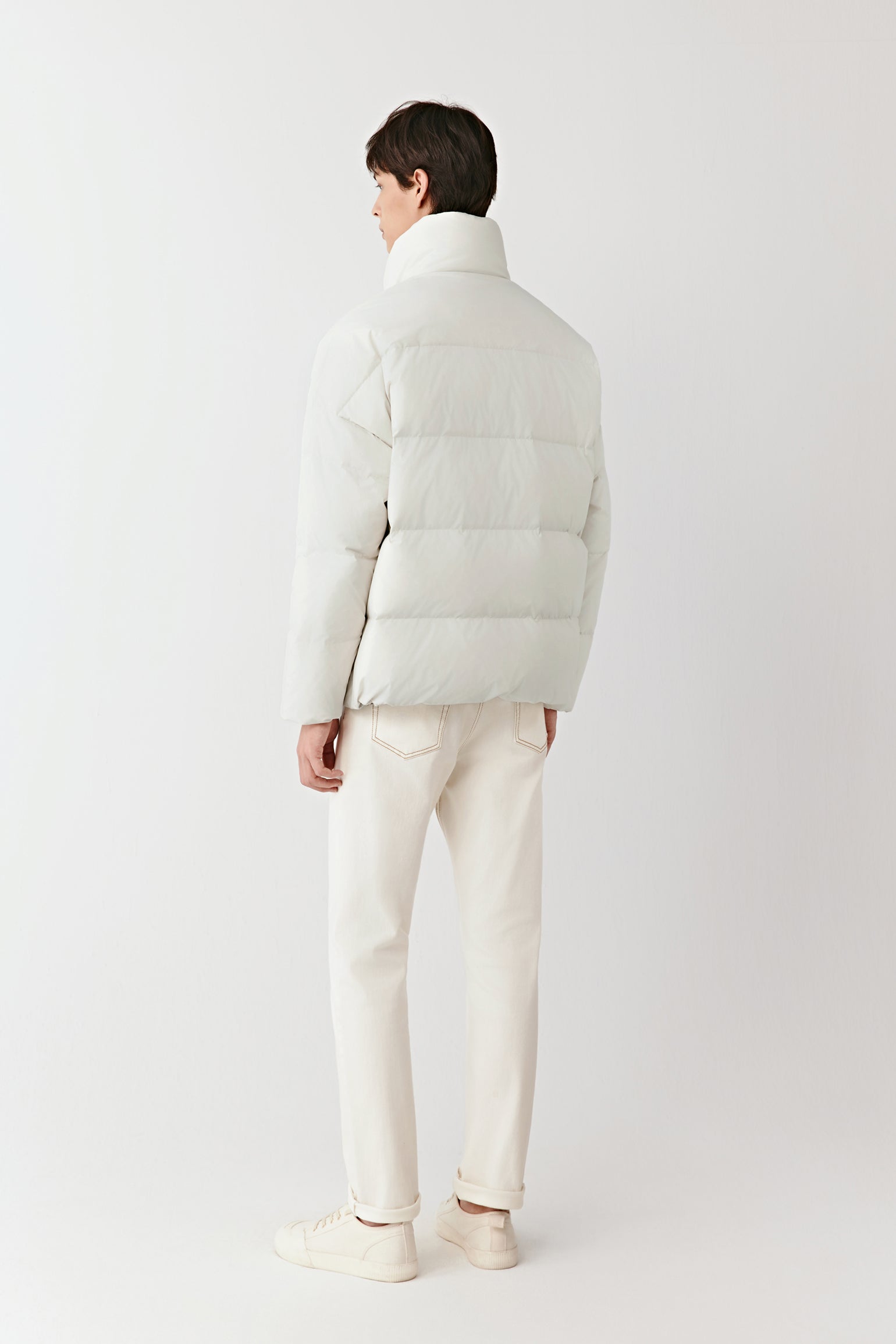 Back view of the cream recycled polyester puffer coat, highlighting the quilted structure and relaxed fit.