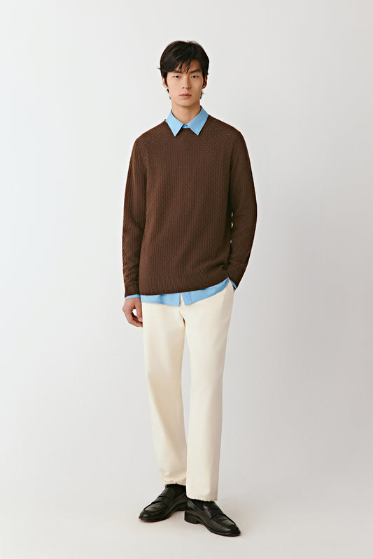 Full-length front view of a person wearing a dark brown wool and cashmere blend pullover with a crew neckline.
