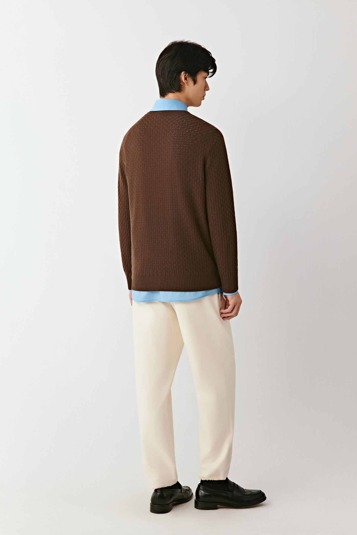 Back view of the brown pullover, highlighting the even knit and clean construction.