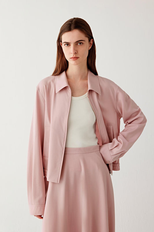 Three-quarter front view of the wool twill jacket, showing the fluid drape, clean front panels and subtle structure at the shoulders.