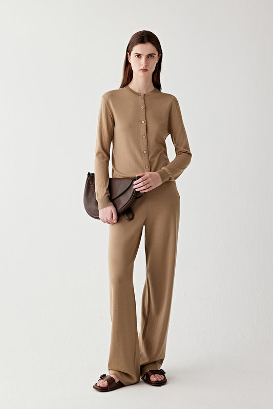 Full-length front view of a wool cardigan in a warm camel shade, worn buttoned for a clean, structured look.