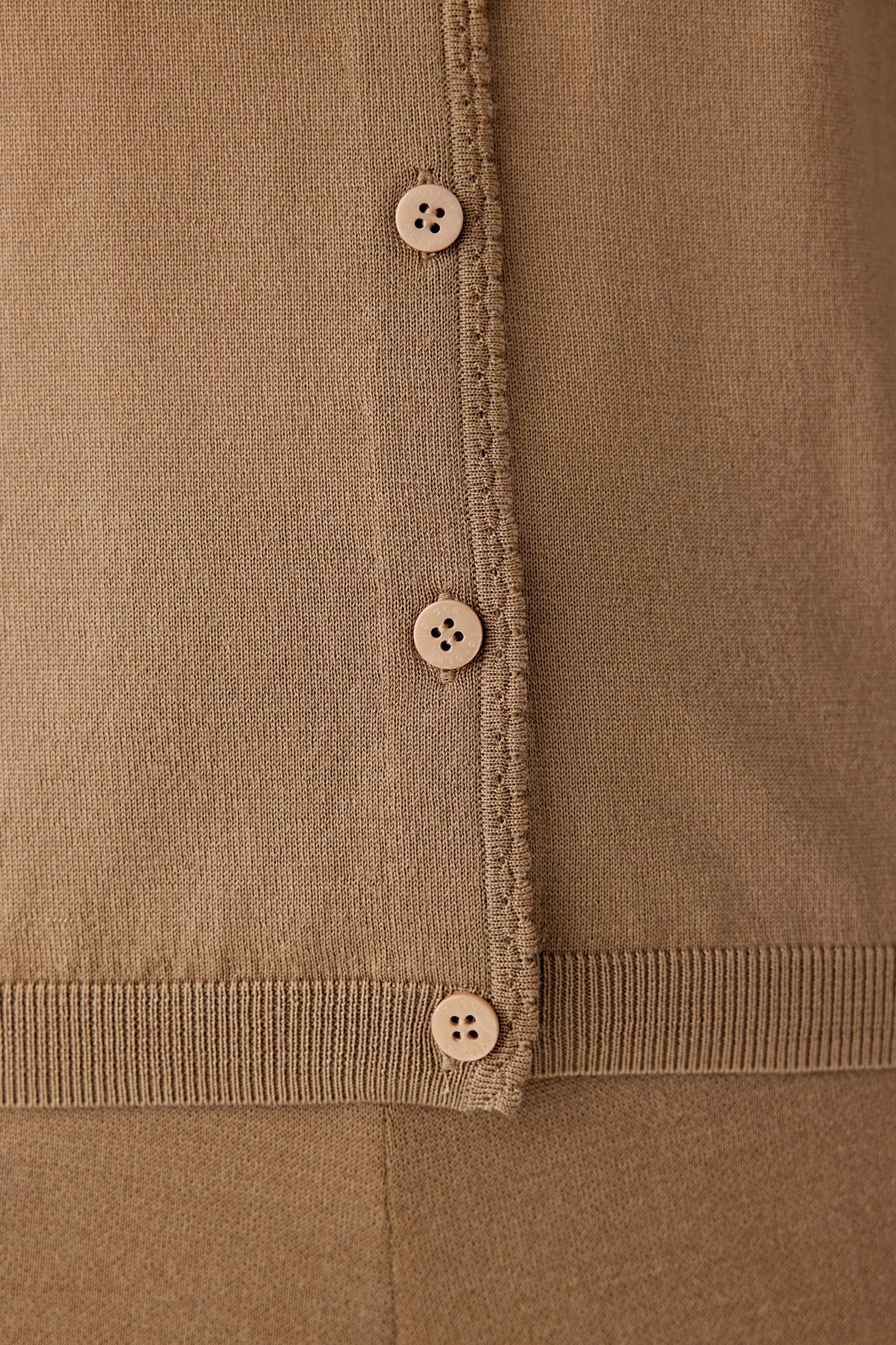 Close-up of the knit texture and sleeve, showing smooth wool finish and tonal stitching.