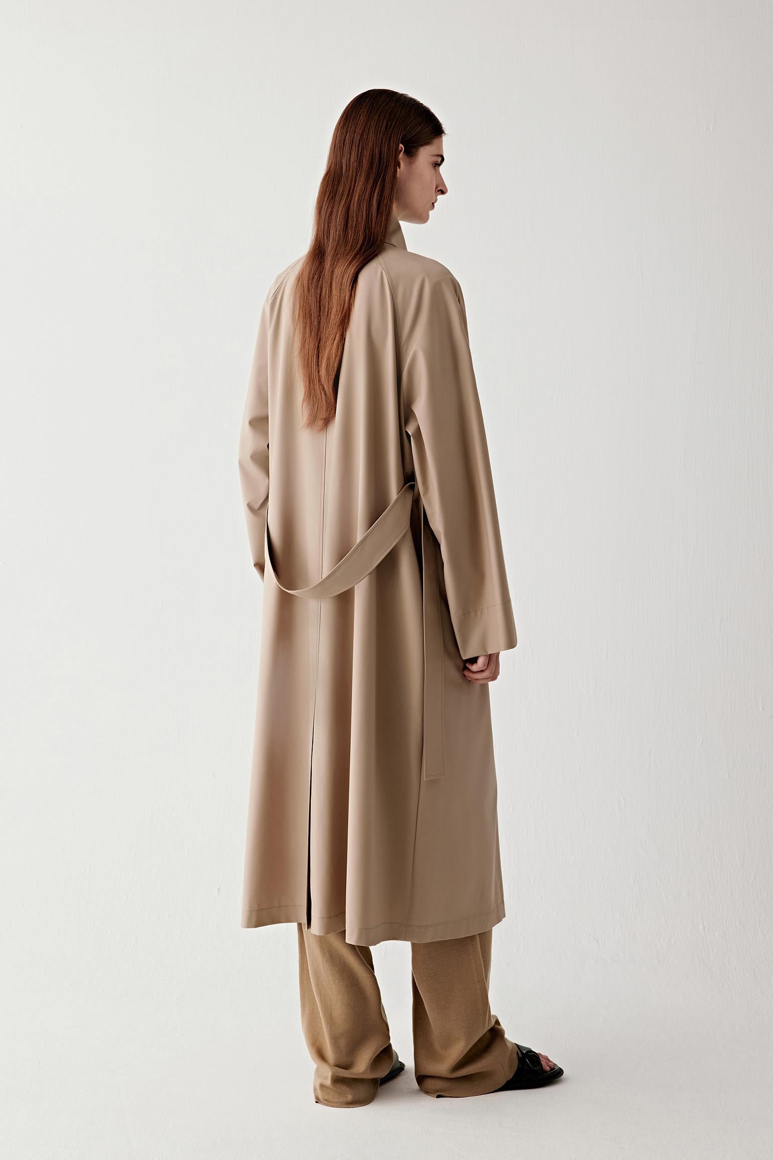 Full-length side view showing the coat’s straight cut, balanced proportions, and natural movement.