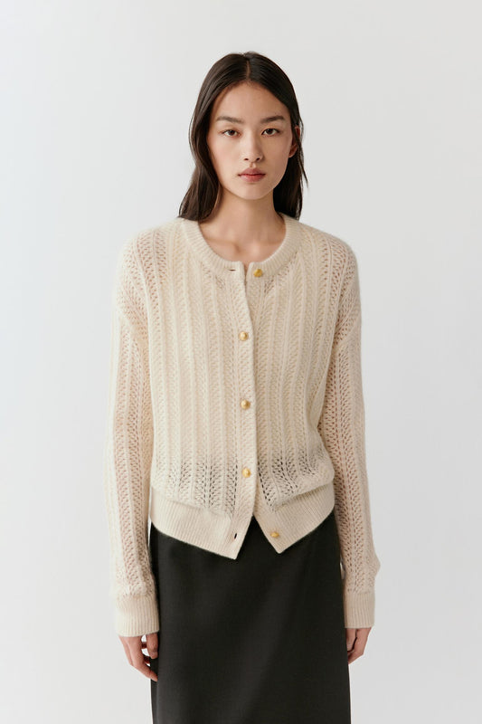 Three-quarter front view highlighting the button placket, ribbed edges, and soft drape.