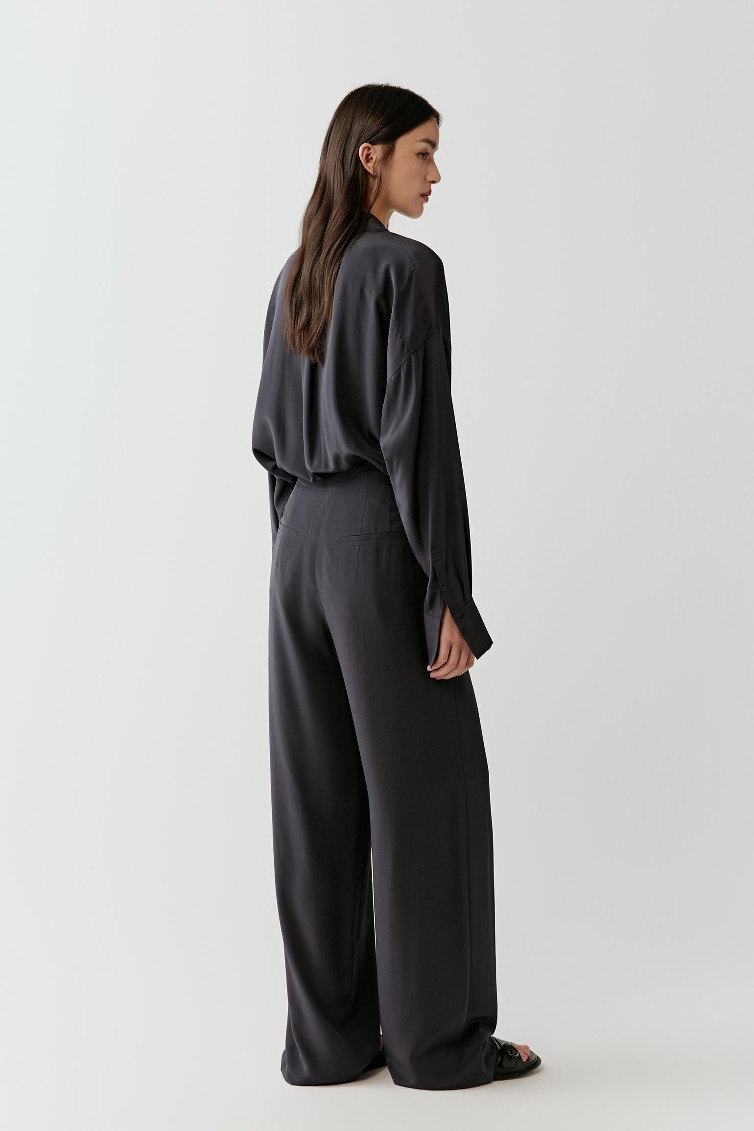 Side view emphasizing the lightweight drape of the silk and the relaxed fit along the body and sleeves.