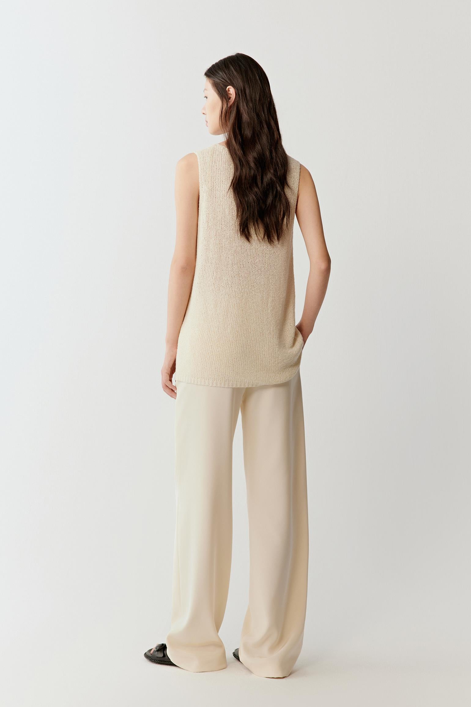 back view showing the soft structure, open armholes and fluid drape of the silk knit.