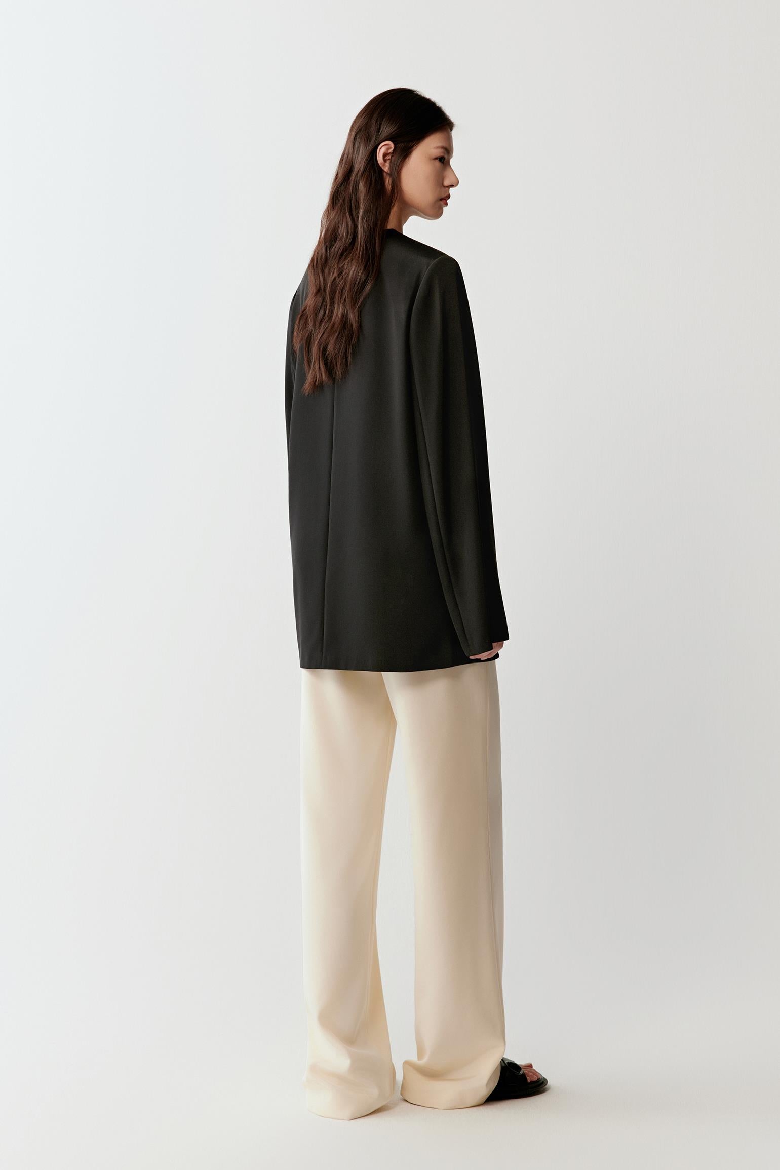 Side view showing the smooth drape, straight cut and minimal construction at the shoulders and back.