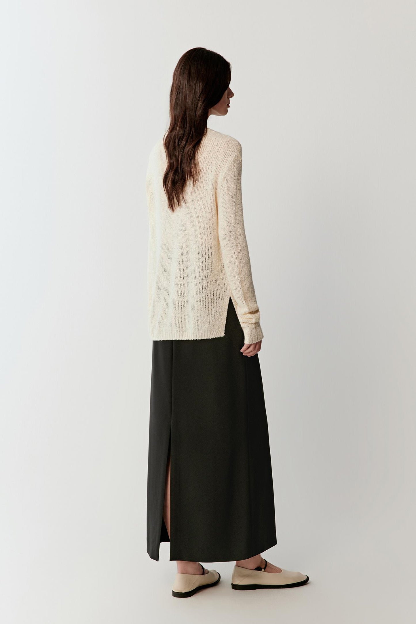 Back view showing the length of the pullover, fluid fall and airy structure of the knit.