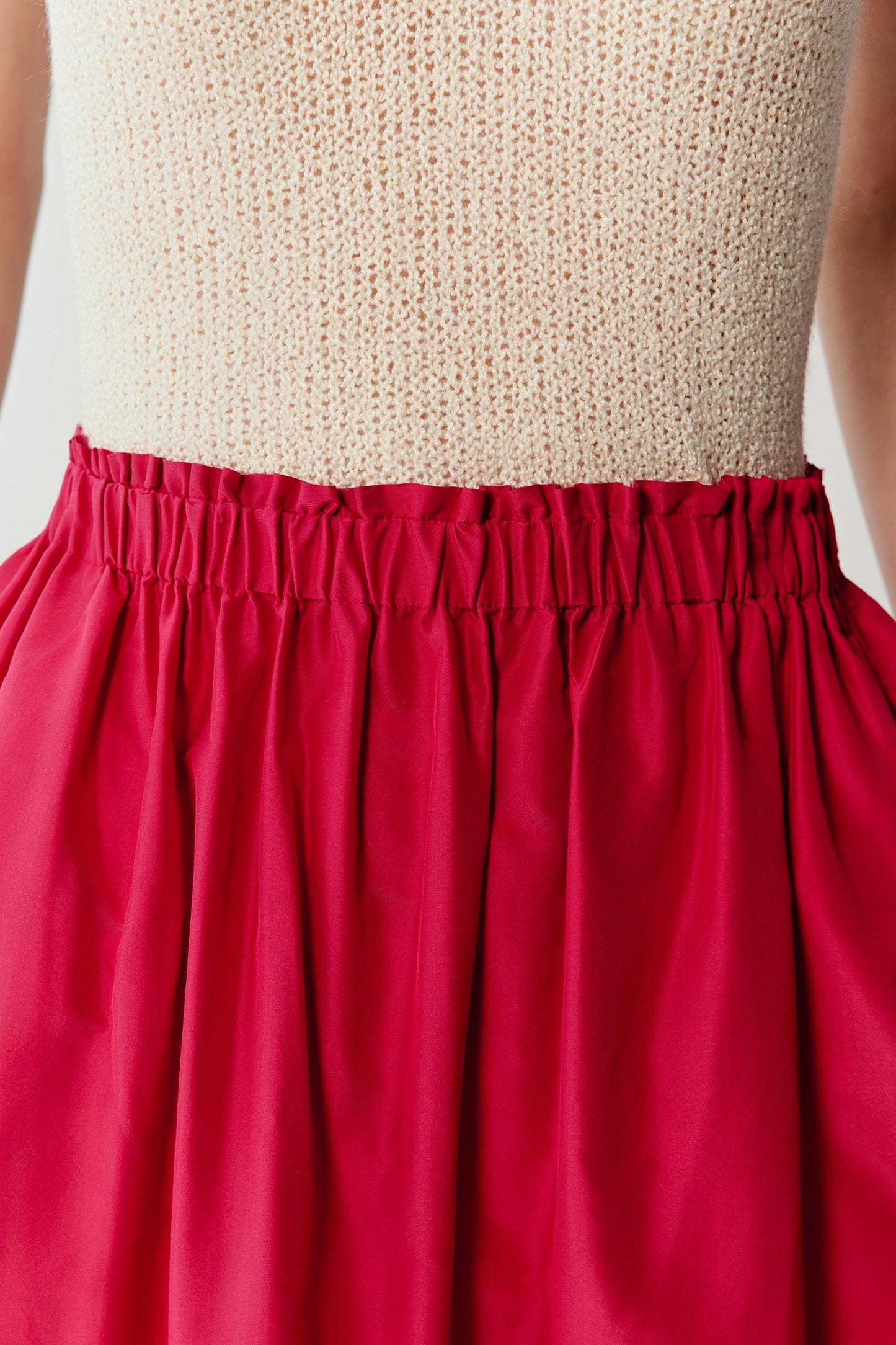 Close-up of the waistband and upper fabric, detailing the elasticated waistband, gathered stitching and the smooth, slightly crisp texture of silk taffeta, with a compact weave and subtle sheen