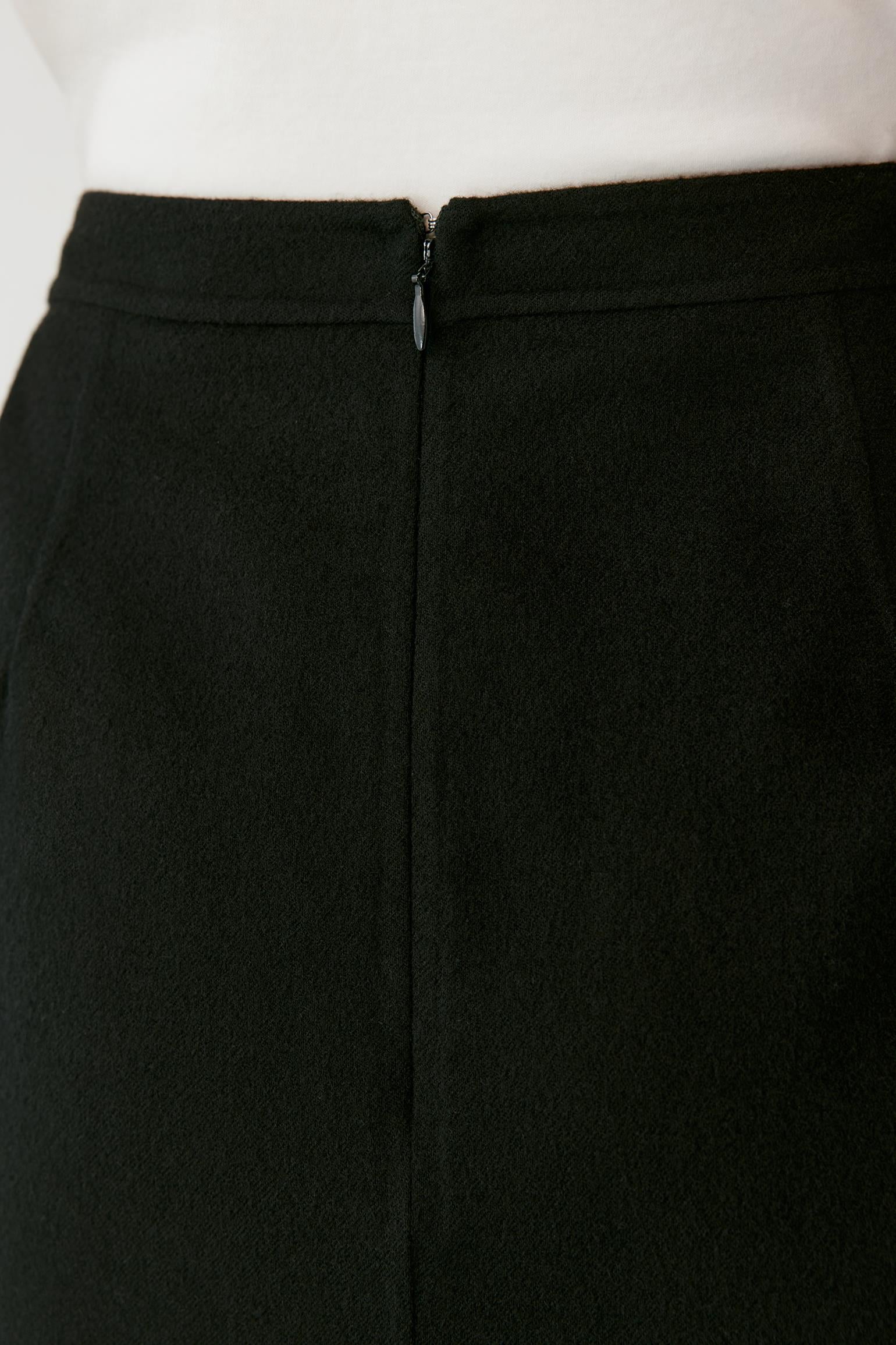 Close-up of a black skirt or pants with a front zipper, shown on a white mannequin torso against a white background.