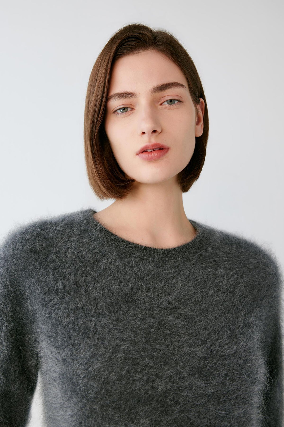 Front close-up highlighting the round neckline and lightly brushed texture of the smoky grey cashmere pullover.