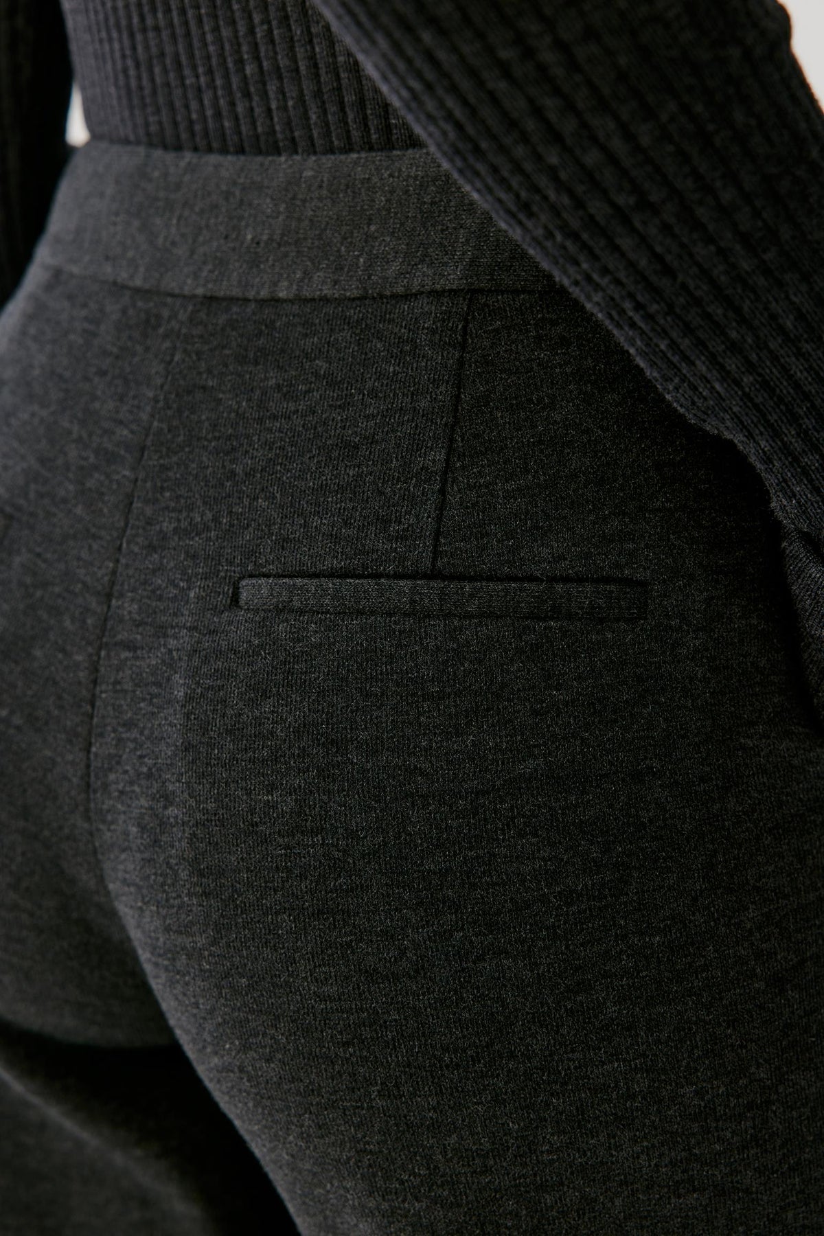 Close-up of the back highlighting the clean construction and dark grey melange jersey texture.