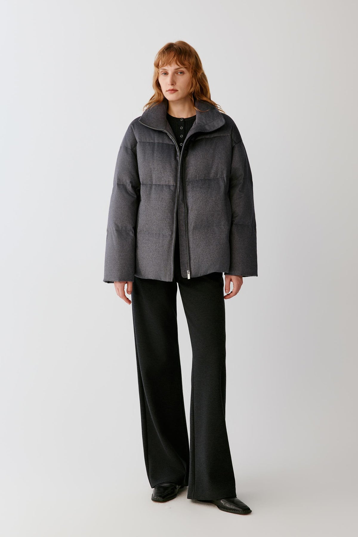 Full-length view highlighting the structured shape, horizontal quilted panels and dark grey melange silk tweed surface.