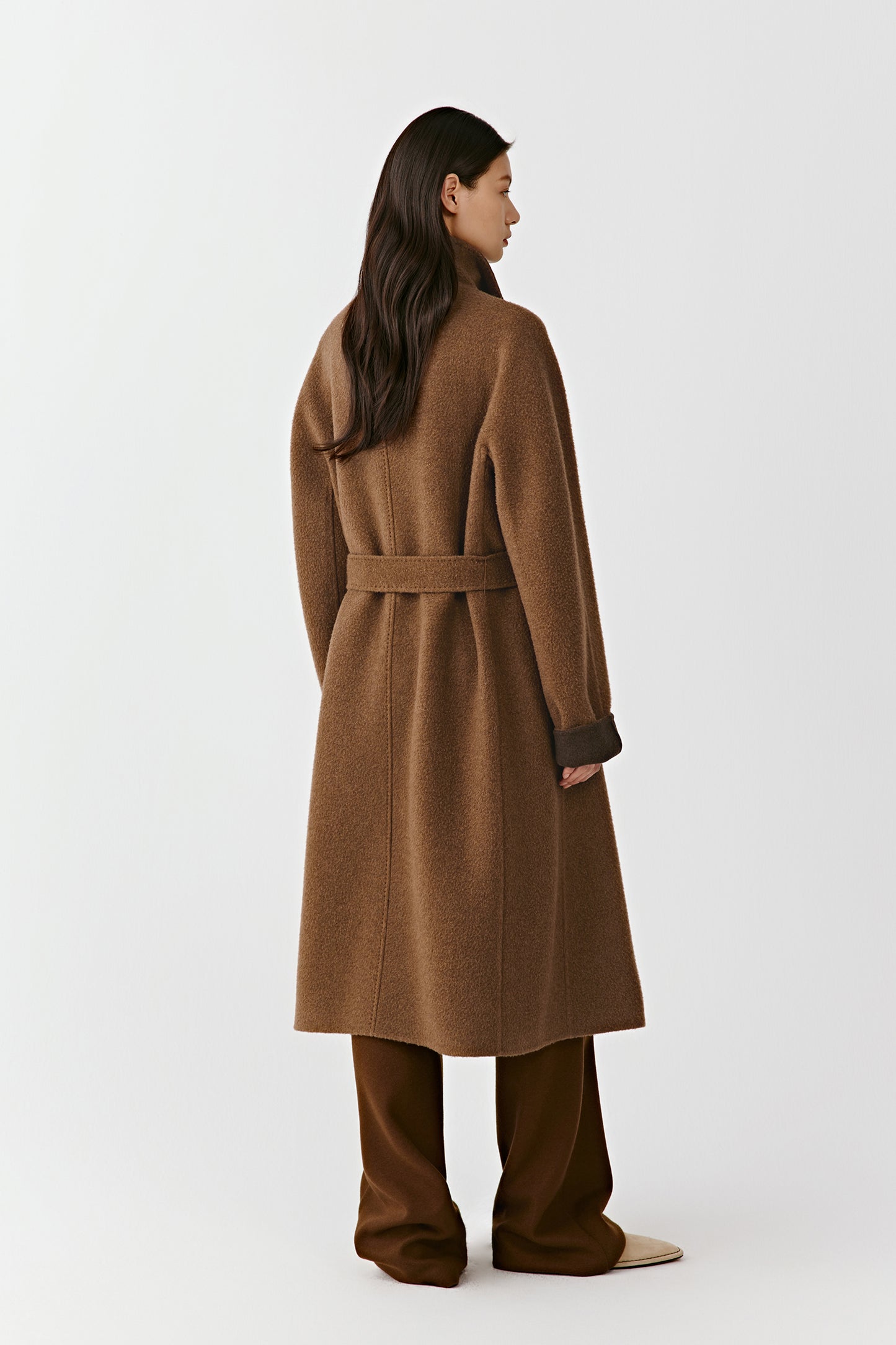 The rear of the coat reveals the clean, flowing lines and subtle tone variation along the seams.