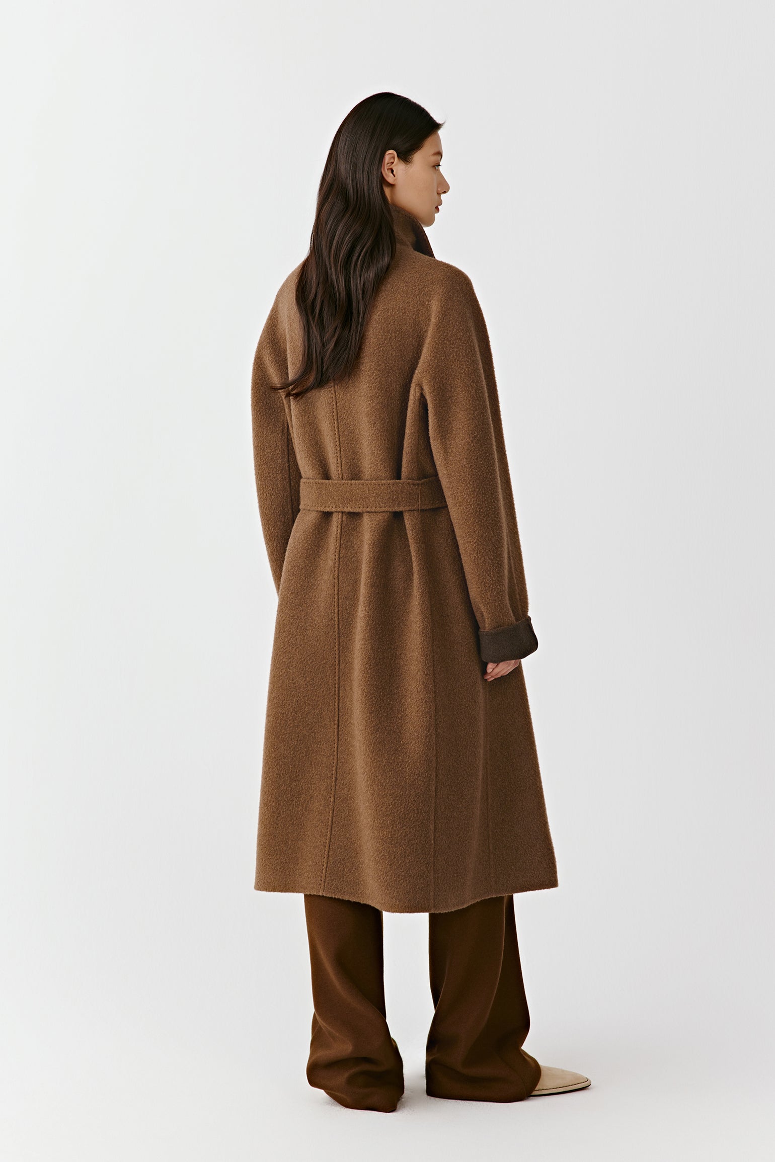 The rear of the coat reveals the clean, flowing lines and subtle tone variation along the seams.