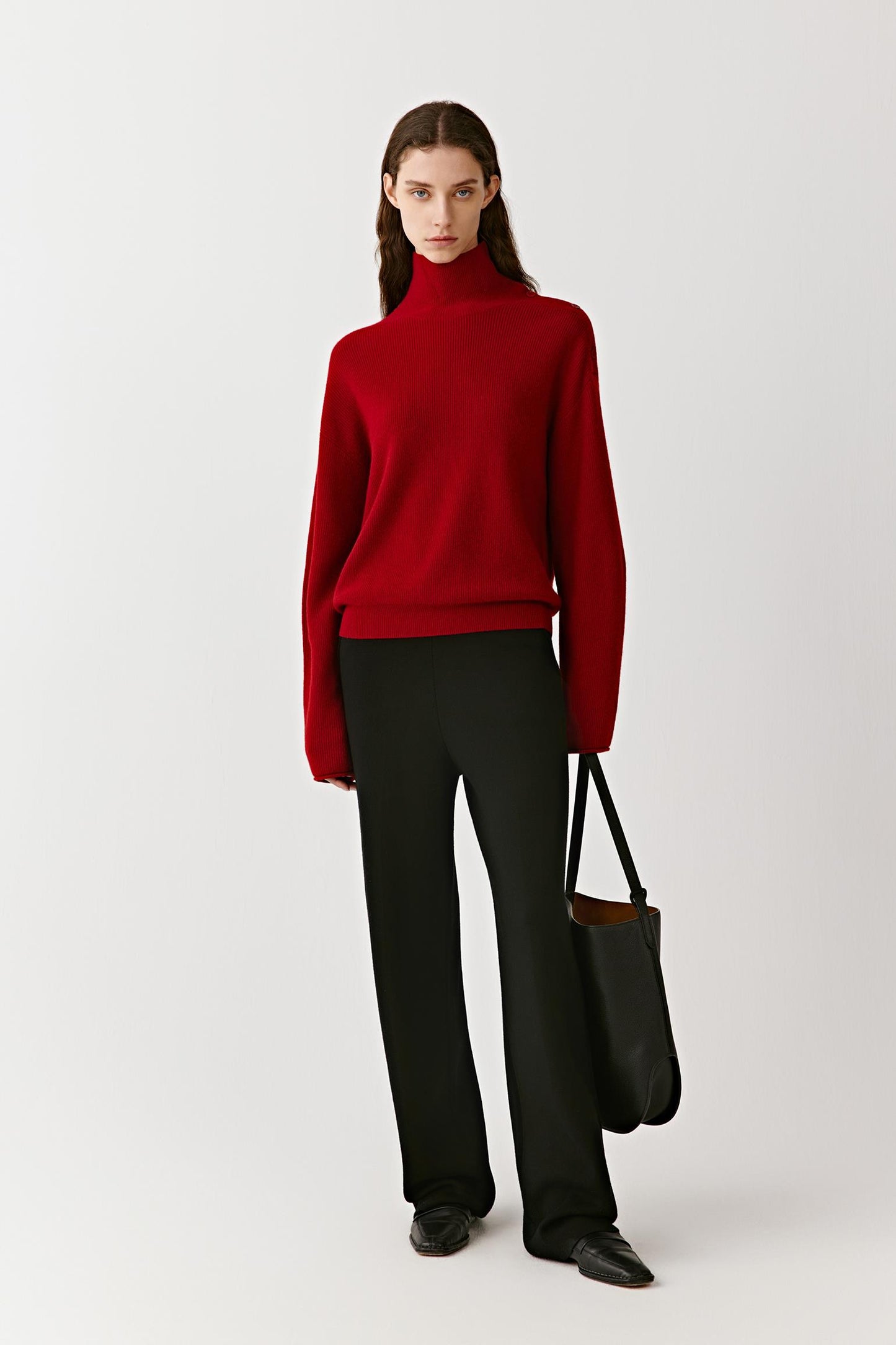 Full-length front view of a red high-neck cashmere pullover with clean lines and a fitted silhouette.