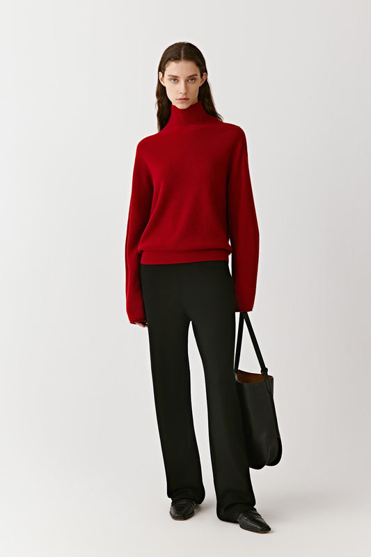 Full-length front view of a red high-neck cashmere pullover with clean lines and a fitted silhouette.