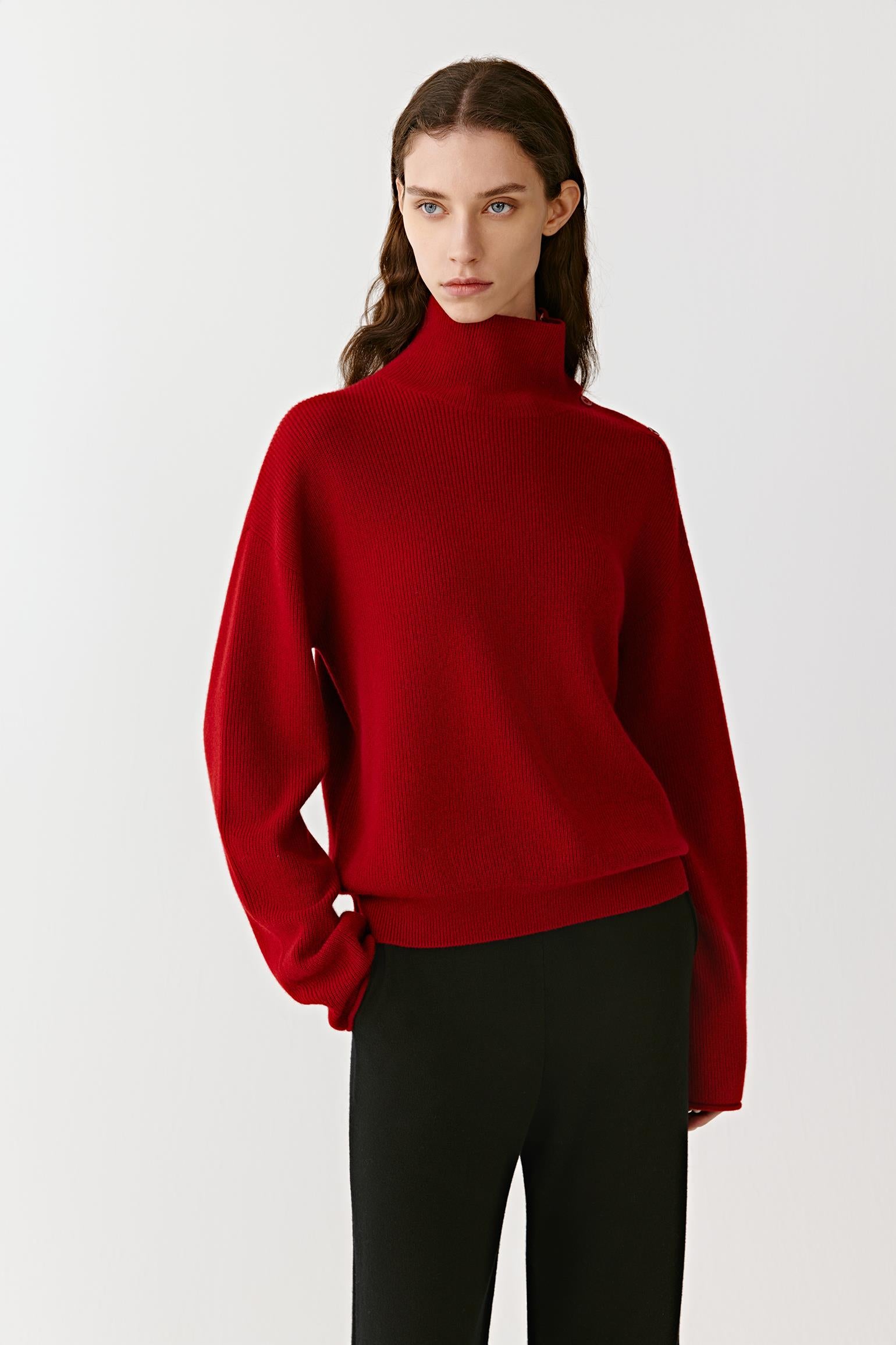 Three-quarter view highlighting the soft texture and structured fit of the red high-neck cashmere pullover.
