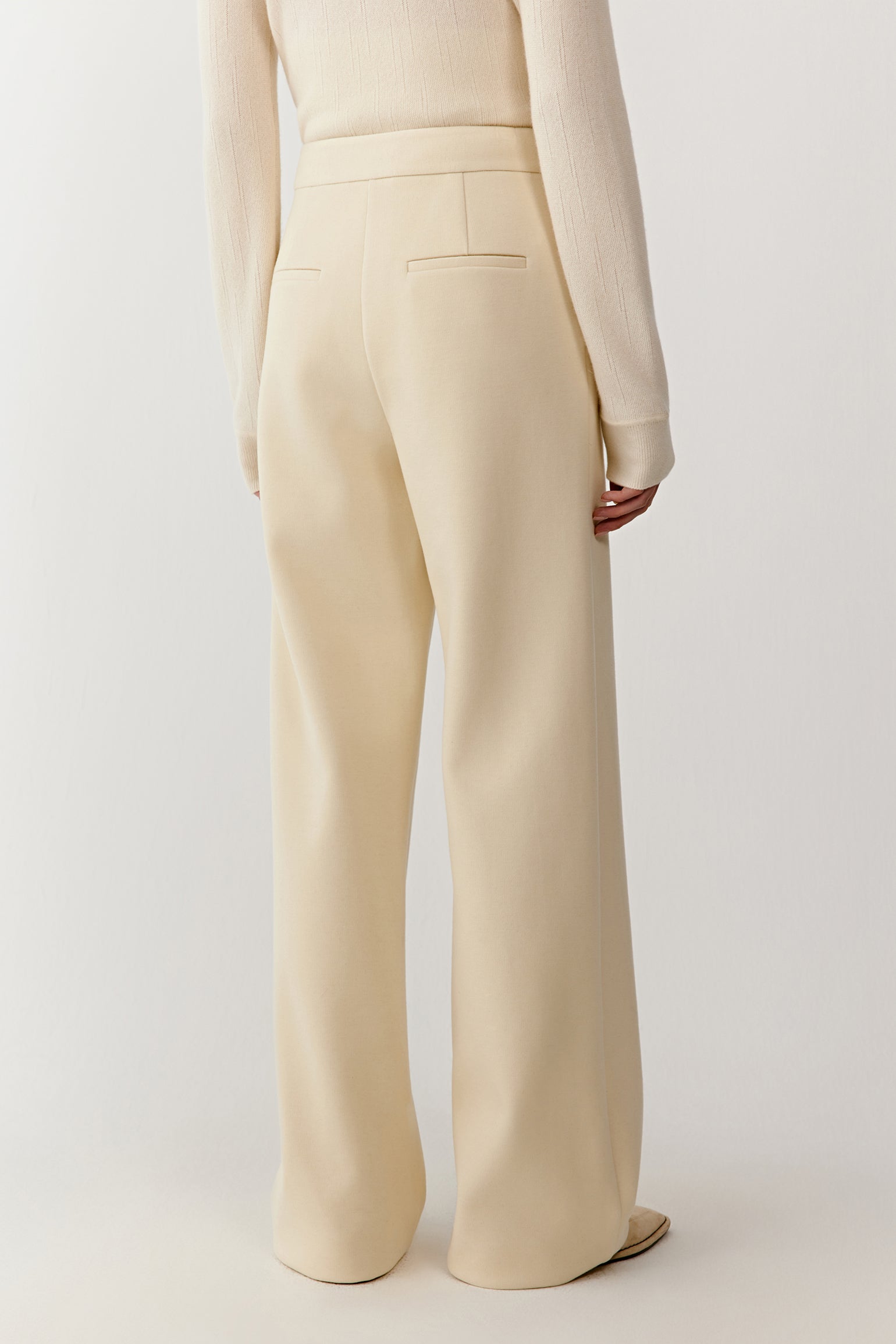 Side view of the straight-leg jersey trousers, highlighting a soft drape and comfortable fit.