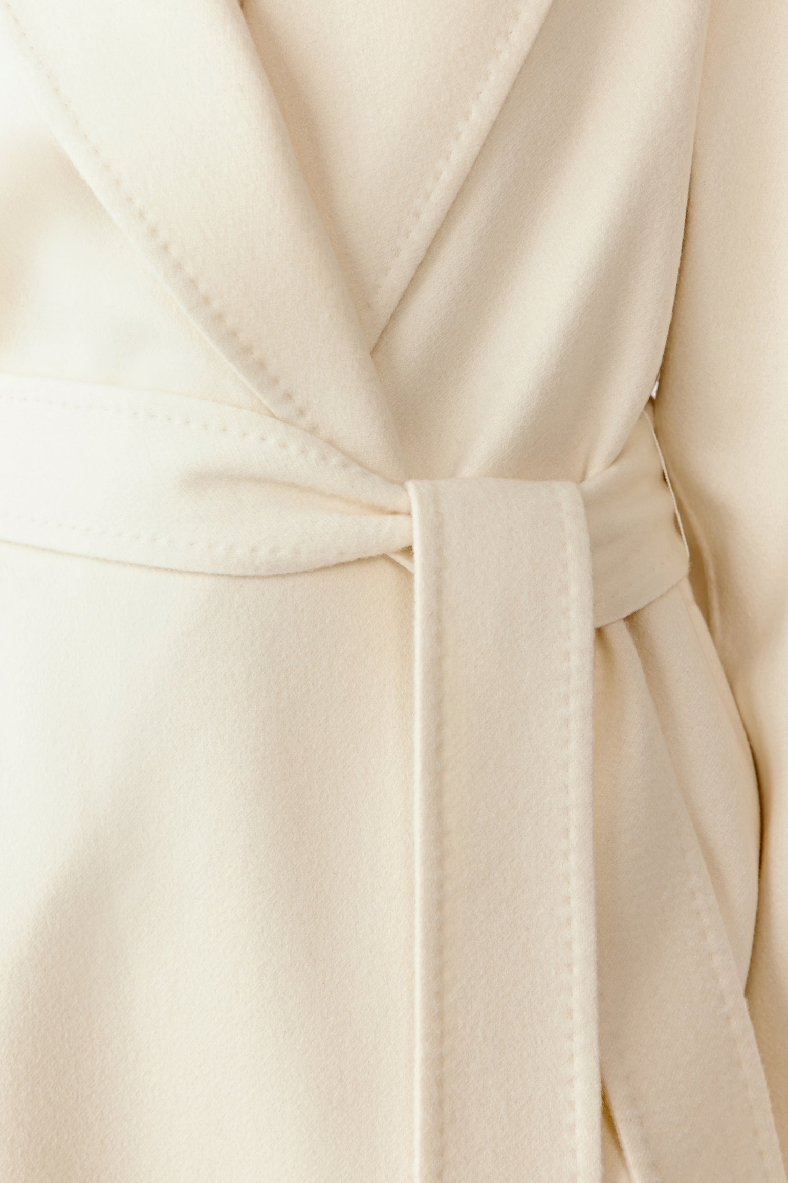 Close-up of the shawl collar and matching belt on the double-faced cashmere coat.