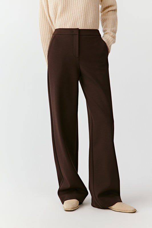 Front view from waist to ankle showing the straight-leg cut and fluid drape of the wool trousers.