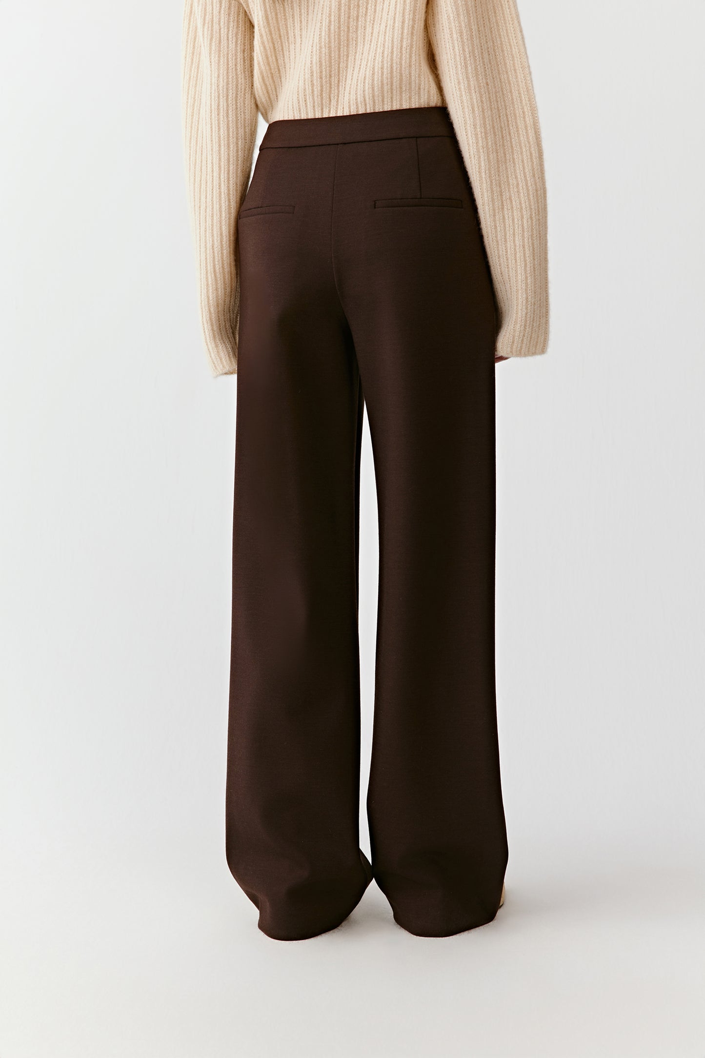 Back view of the straight-leg stretch wool trousers, highlighting clean lines and a structured fit.
