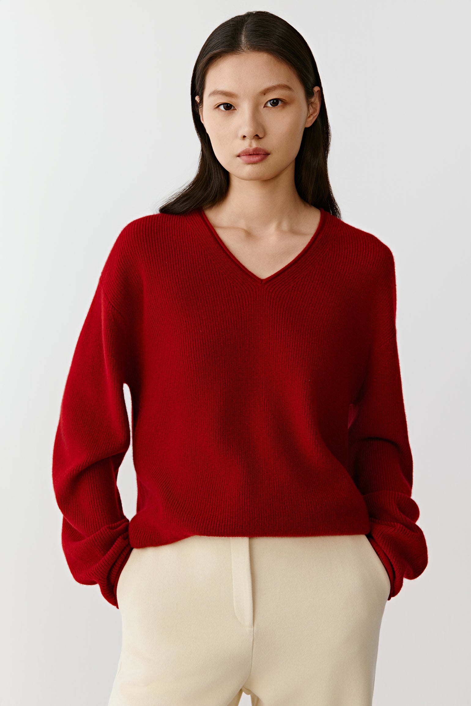 Front view of the red cashmere pullover, showing a relaxed fit and refined knit texture.
