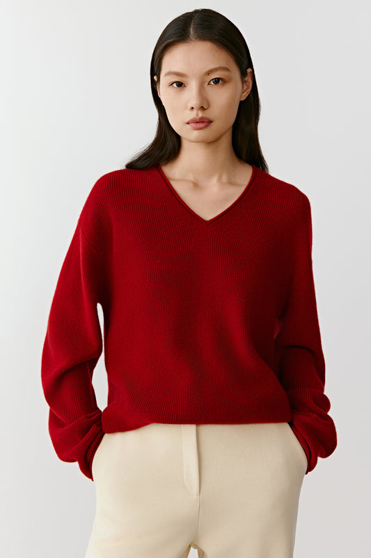 Front view of the red cashmere pullover, showing a relaxed fit and refined knit texture.
