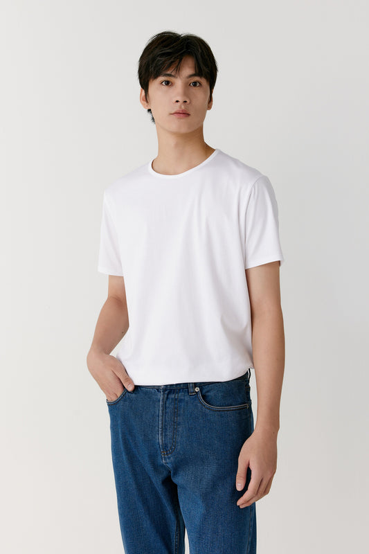 A close-up captures the fine weave and the even stitching at the neckline and sleeves under natural light.