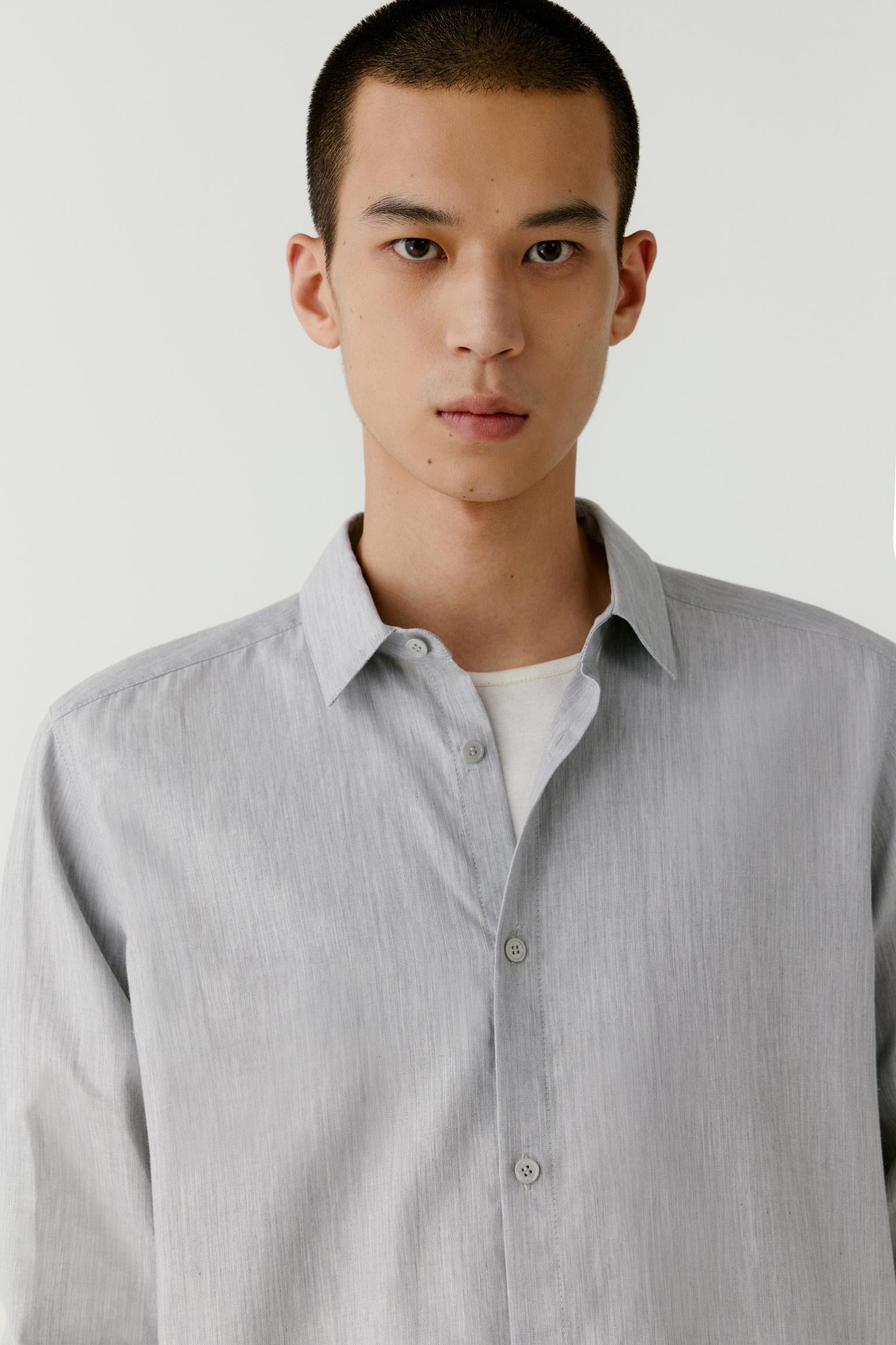 Portrait close-up highlighting the collar and button placket.