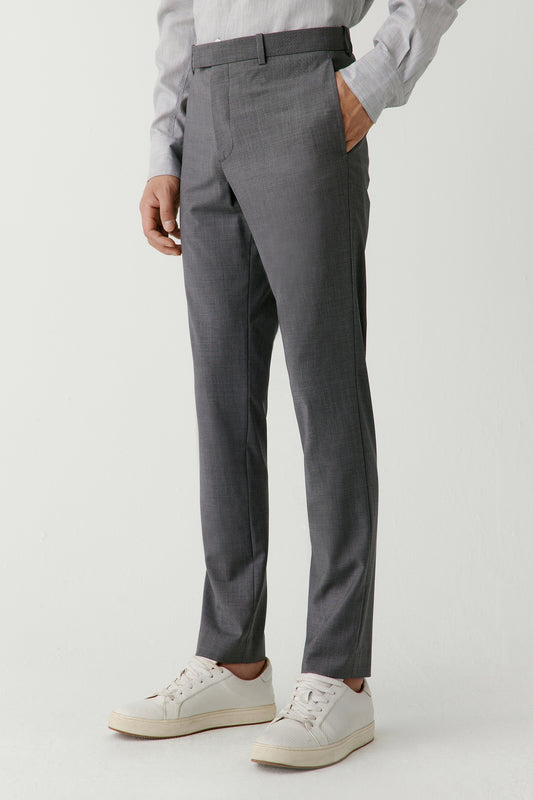 Three-quarter view highlighting the clean slim silhouette and fluid drape of the wool fabric.