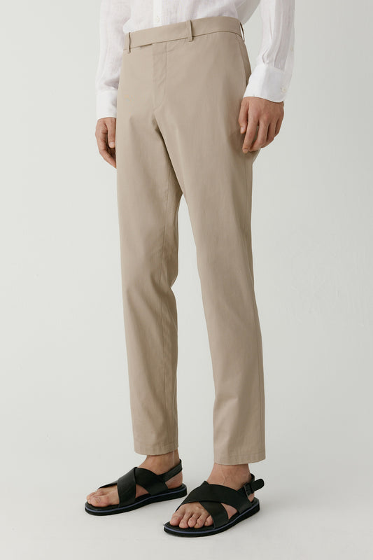 Three-quarter view highlighting the clean slim silhouette and stretch cotton fabric.