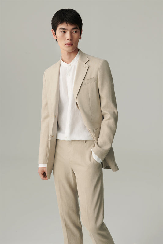 Three-quarter front view showing the notch lapel and relaxed straight silhouette.