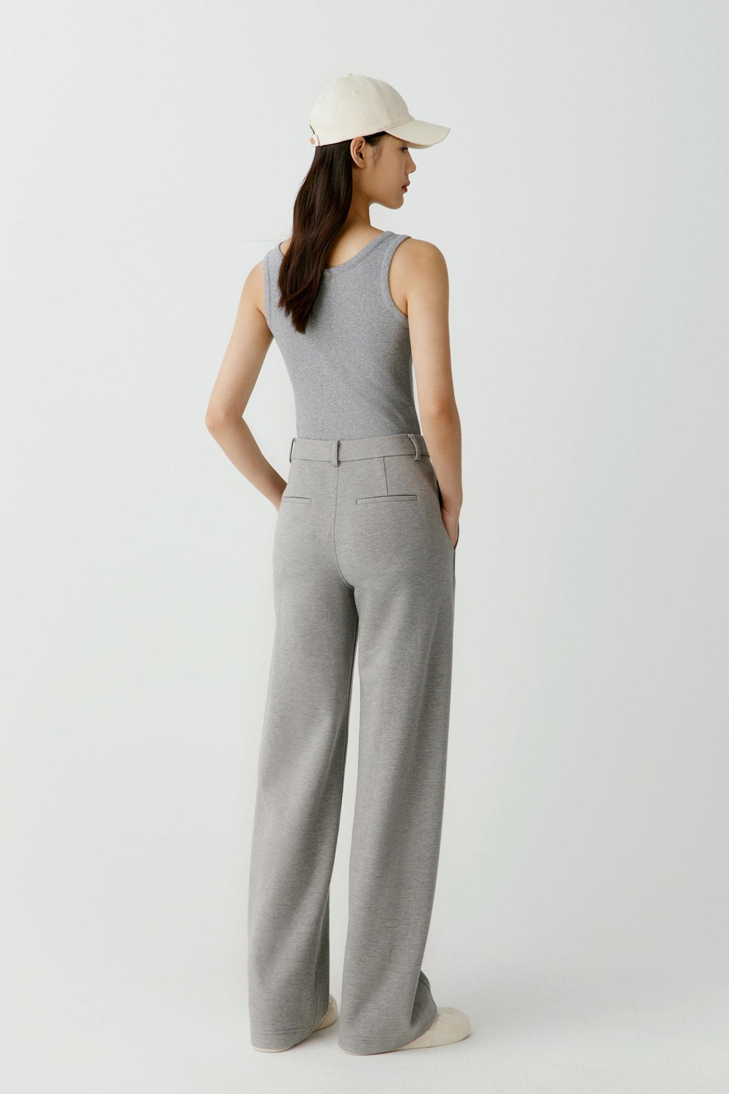 Three-quarter view highlighting the way the ribbed jersey follows the body. The image showcases the fitted shape, clean armhole construction and soft texture of the fabric.