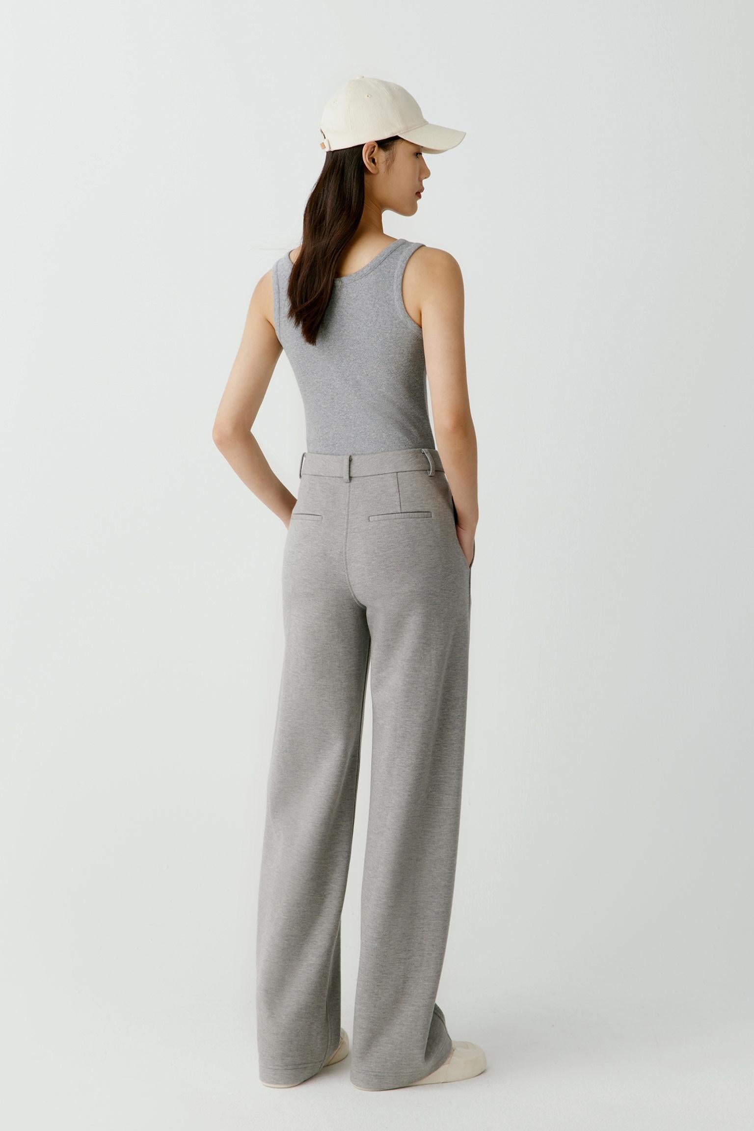 Three-quarter view highlighting the way the ribbed jersey follows the body. The image showcases the fitted shape, clean armhole construction and soft texture of the fabric.